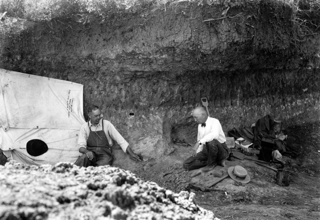 Carl Schwachheim (left) shows the Folsom point, in its original excavation context, to visiting<br />paleontologist Barnum Brown on September 4, 1927. © Denver Museum of Nature & Science