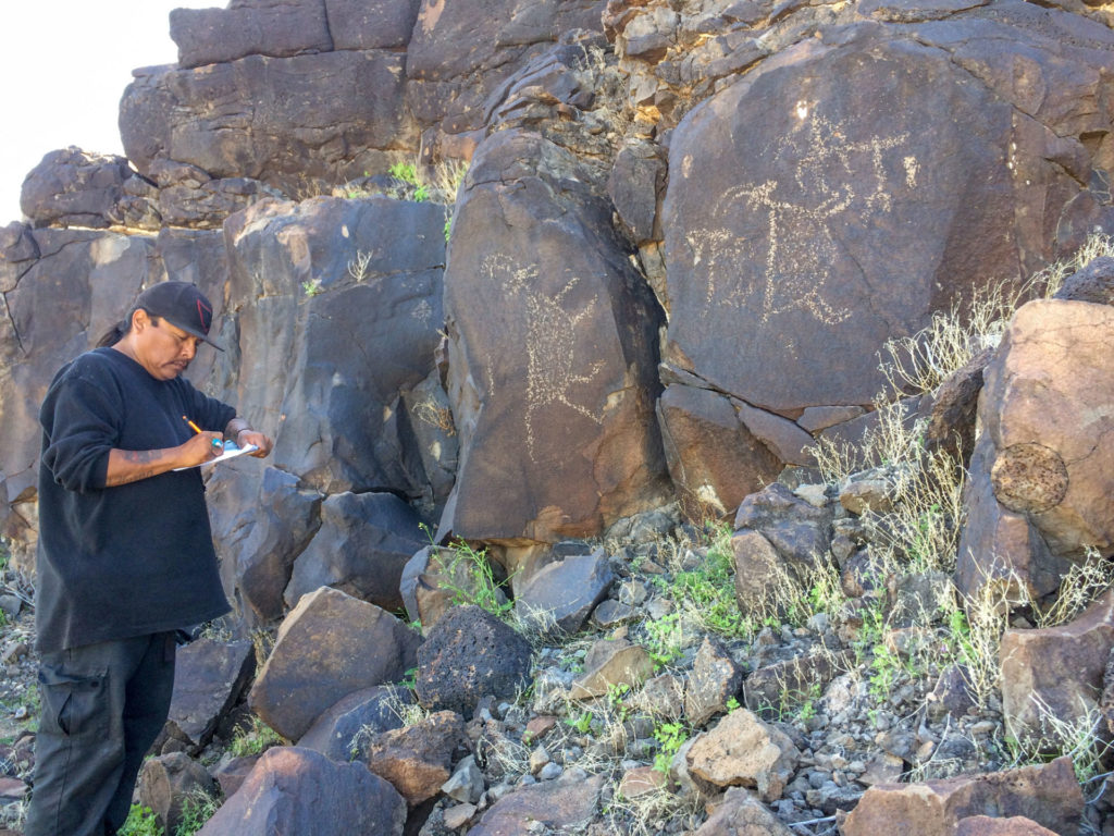 Jason Andrews documenting a series of petroglyph panels.