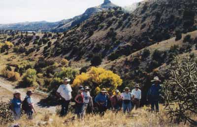 <em>An Earthwatch volunteer group touring the Pinnacle Ruin, one of several sites located in Cañada Alamosa.</em>