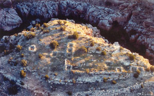 Architectural evidence for warfare in the Chevelon drainage; recent investigations at this fortified settlement revealed at least 23 rooms and a series of defensive walls across its gentler slopes.
