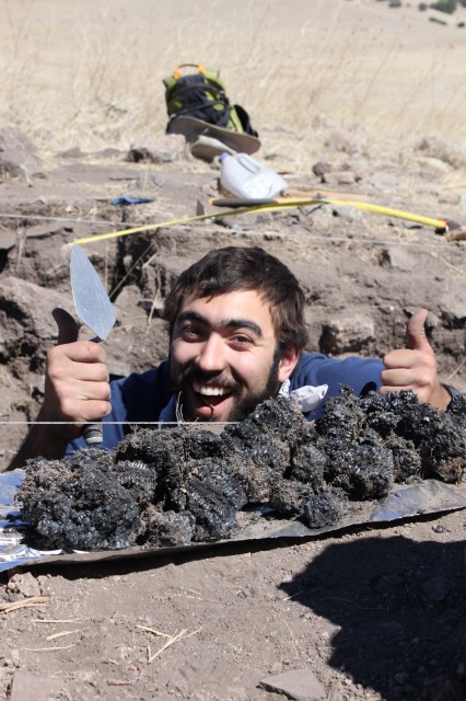 Jake (Hendrix College) with the newly excavated burnt corn. (Photo credit: Dan Weinberger)