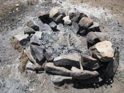 Campfire ring made from prehistoric masonry walls in roadside camping area.