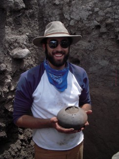  2011 field school student holds a seed jar excavated at the Fornholt site.