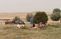 Students relaxing at the fire pit after a hard day’s work. Click to enlarge.