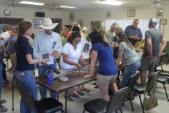 Community members gather at our show-and-tell table inside the Gila Senior Center. Click to enlarge.