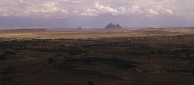 The central Chuska Valley. View from a Pueblo III mesa-top fortress known as The Gap, looking east toward Bennett Peak (big volcanic peak) and Ford Butte (smaller one), 1998. Click to enlarge.