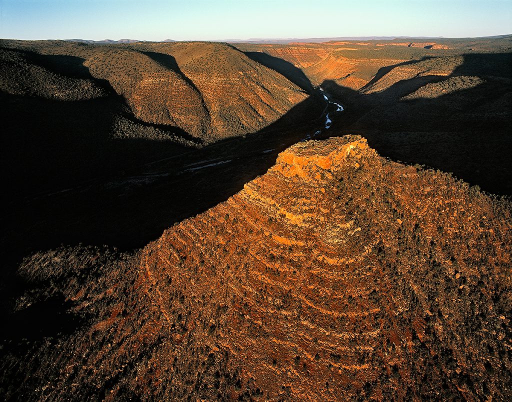 Butte with Ruins in River Canyon