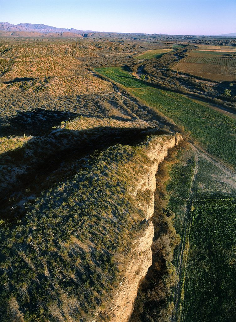 Ruins on Cliff above River Valley