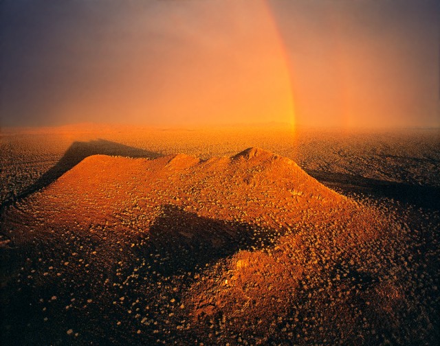 Volcanic Hill with Terraces under Rainbow