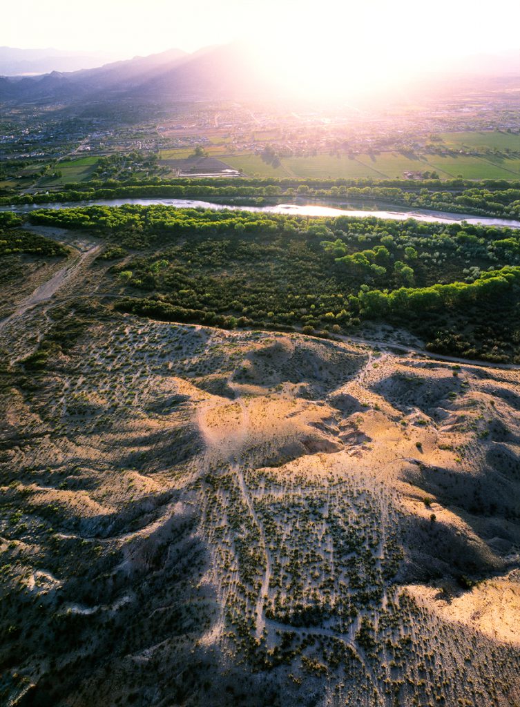 Pueblo Ruin above River at Sunset