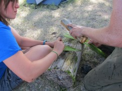 Making cord out of plant fiber. Click to enlarge.