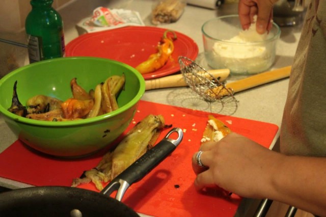 Preparing chiles rellenos.