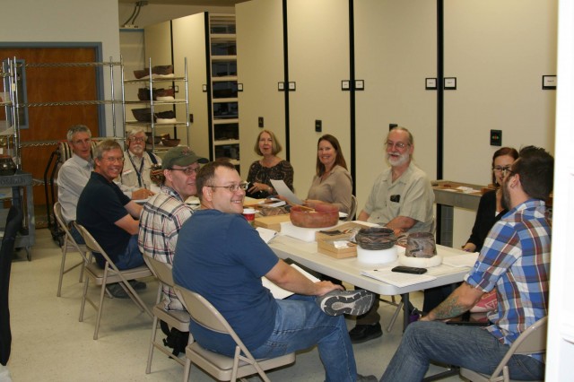 A recent gathering of <span style="text-decoration: line-through">sherdnerds</span> experts in the Pottery Vault at the Arizona State Museum. We happily spent four hours discussing the pottery of southern Arizona. Clockwise from foreground: (solid blue shirt) me, Jeff Clark, Henry Wallace, Bill Doelle, Mike Jacobs, Barbara Mills, Deb Huntley, Jim Heidke, Mary Ownby, Lewis Borck. Photo by Patrick D. Lyons, courtesy of the Arizona State Museum.