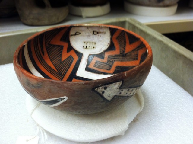 Pinedale Polychrome bowl with a masked figure on the interior and a snake on the exterior.