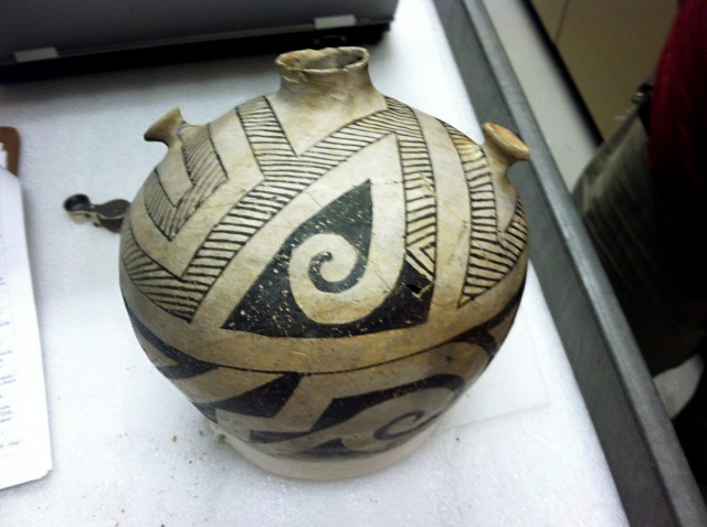 Socorro Black-on-white canteen with interesting design. Note that the upper part of the vessel has a hatched design that becomes a solid design. The lower part of the vessel continues that solid design. Note, too, the interesting lugs, or knobs, (or Shrek ears?) on each side of the vessel’s opening. Twine was probably attached to these in order to hang the vessel.