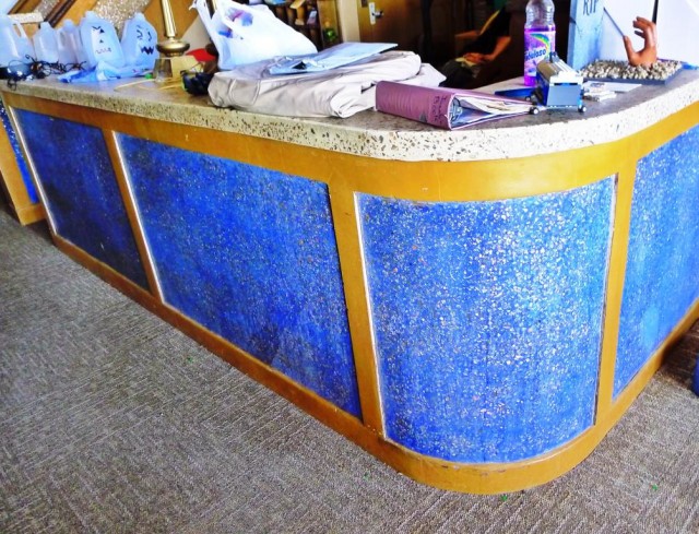 Lobby desk. Note the abalone shell in the counter top (detail below).