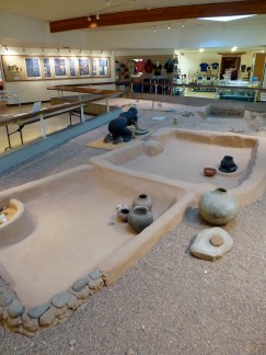 This reconstruction portion of the Pueblo Grande de Nevada site shows the excavation process as well as several artifacts recovered here and a woman grinding corn. Again, these reconstructions sit directly on top of the original walls. Click to enlarge.