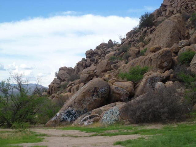 Graffiti-laden hills at another Apache pictograph shelter. Photo by Andy Laurenzi. Click to enlarge.