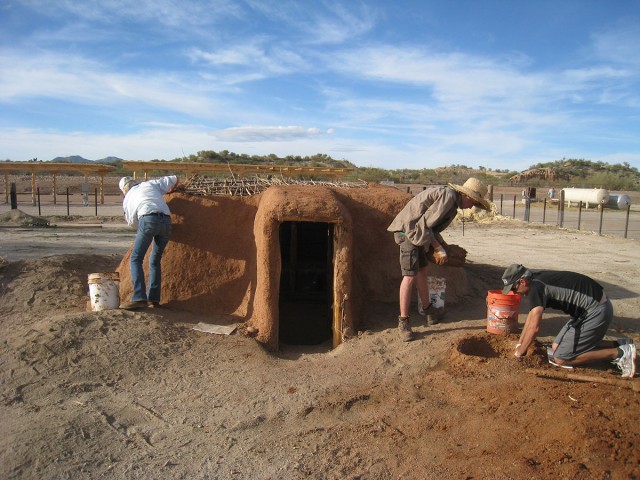 Mudding the pithouse. Photo by Allen Denoyer.