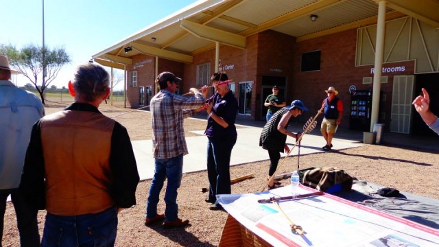 Allen teaches guests how to throw with an atlatl.