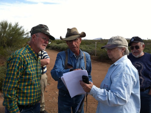 We consult our maps to locate the inscription. From left to right: Tom Randall (my father), Dave Stanton (our guide), Rose Ann Tompkins (our guide), Harland Tompkins.