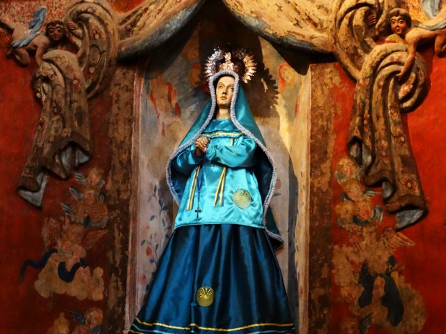 Photo of Mother Mary with the Man in the Maze on her dress at San Xavier Mission.