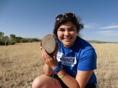 Selena (me) holding a mano (handstone for grinding) at Gamelstad site.