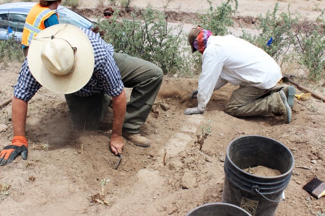 Experienced archaeologists preparing the unit for further excavation.