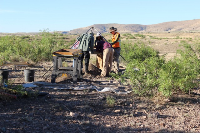 Students work together to sort artifacts in the field.