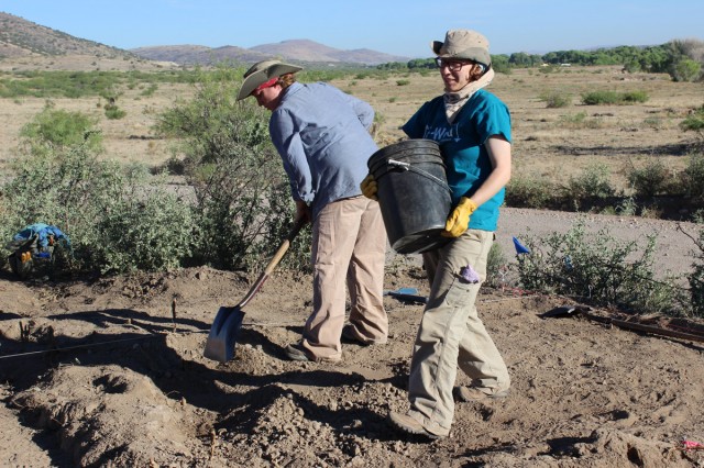 Danielle and Kaelyn search for the walls of a prehistoric adobe room.