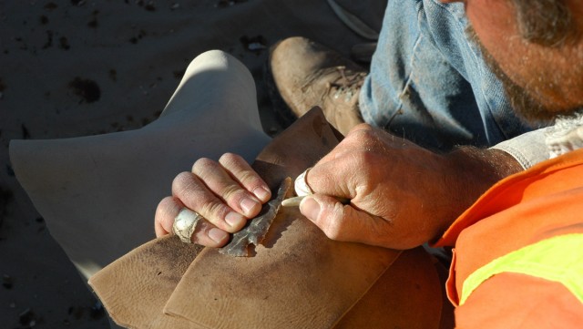 Allen demonstrates flintknapping.