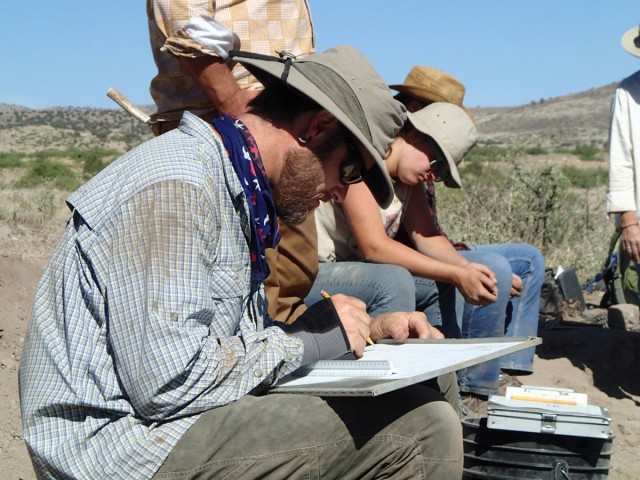 The field school crew draws maps and profiles of walls and floor features in our excavated rooms. Photo by Karen Schollmeyer.