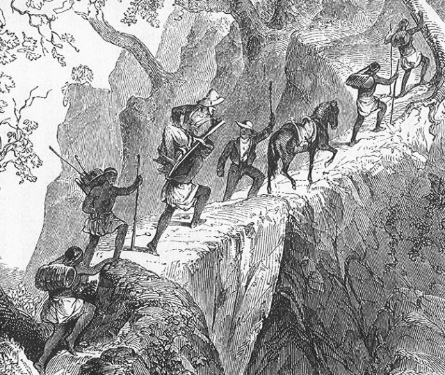 The pioneer explorer of Central America, John Lloyd Stephens, carried on the back of a local bearer in his expedition to Palenque, circa 1840. By Frederick Catherwood (public domain), via Wikimedia Commons.