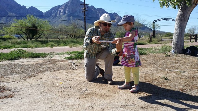 Lewis Borck shows a young huntress how to use an atlatl at Steam Pump Ranch.