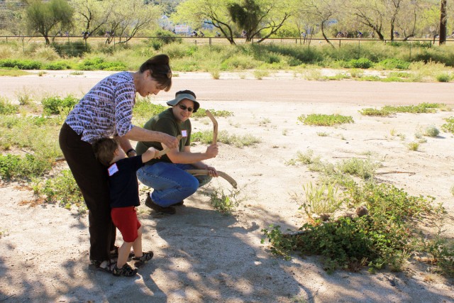Matt Peeples shows a young hunter-in-training how to use a rabbit stick.
