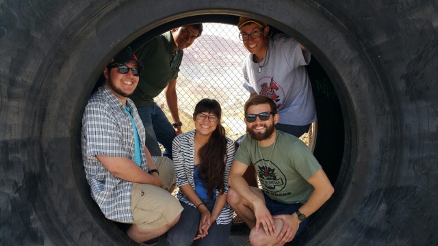 Connor, Dushyant, Alec, Joe, and Victoria in a giant tire near the Santa Rita Copper Mine.