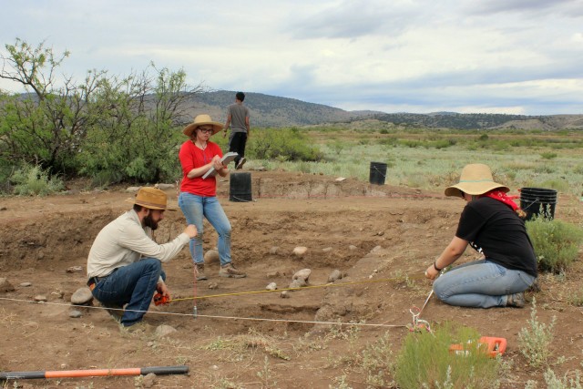 Joe, Devinne, and Alexandra N. map artifacts in their excavation unit.