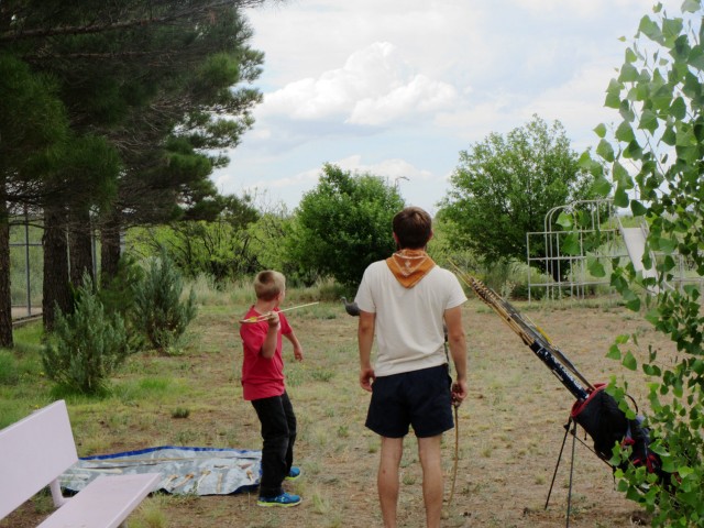 <br />Joe shows a young visitor how to use the atlatl. Photo by Karen Schollmeyer.
