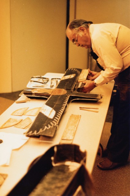 Dr. Joe Ben Wheat, examining a wooden artifact, now at the Northwest Museum of Arts and Culture (NMAC) in Spokane, WA. Image courtesy of the University of Colorado Museum of Natural History (Copyright University of Colorado Museum of Natural History).