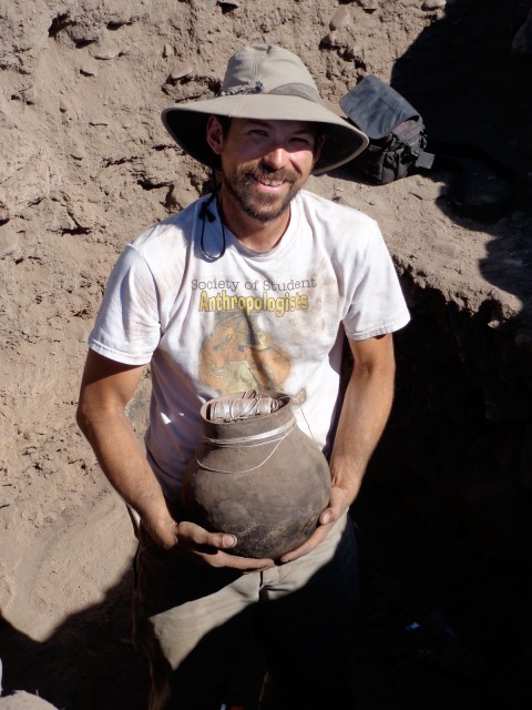Jakob with a complete olla (jar) from Woodrow Ruin excavations.