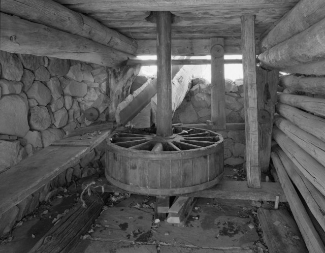 Water Wheel at Grist Mill. The wooden sluiceway depicted in Bill Doelle’s “Back Sight” leads to this mill. Image courtesy of the Library of Congress. Read more <a href="http://www.loc.gov/item/nm0302/" target="_blank" rel="noopener">here</a>.