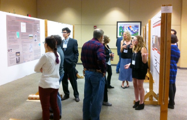 Alexander Ballesteros, Lindsay Shepard, and Alexandra Norwood present their research to the first visitors of the day.