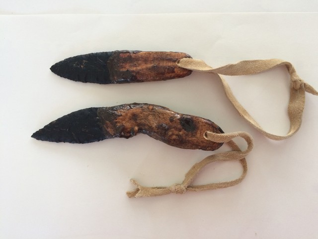 Two knives with hand-straps in place. I like to make sheaths of deer hide sewn with hemp cordage to enclose and protect the knife while it is worn on a lanyard.