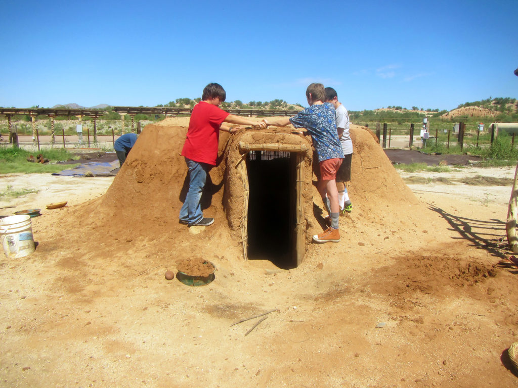 Children helping to build a replica Hohokam pithouse.