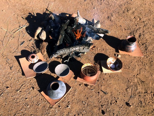 Some Salado polychrome pots and a couple of perforated plates pre-heating around the ﬁre getting ready to be ﬁred. Some of these are re-ﬁres which is why they appear grey.