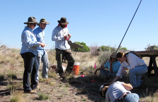 In the field in 2008, demonstrating how to lay out an excavation unit. My in-field fashion sense has not improved.