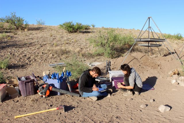 Hannah and Riley discuss field notes during our 2014 field school. Taking accurate field notes that separate our factual observations (the data) from our inferences about them (which often change as we excavate) helps avoid bias in archaeological data collection.