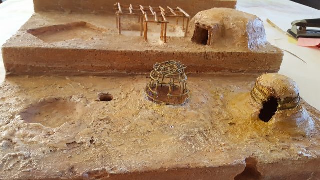 Replica early agricultural period pithouse (bottom) and Hohokam pithouse (top).