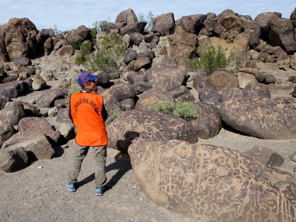 Volunteer Fran Maiuri modeling her orange vest on a survey project at the Painted Rocks Petroglyph site.