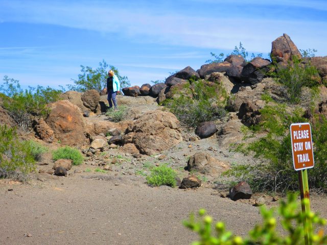 Visitor walking on sensitive boulders.